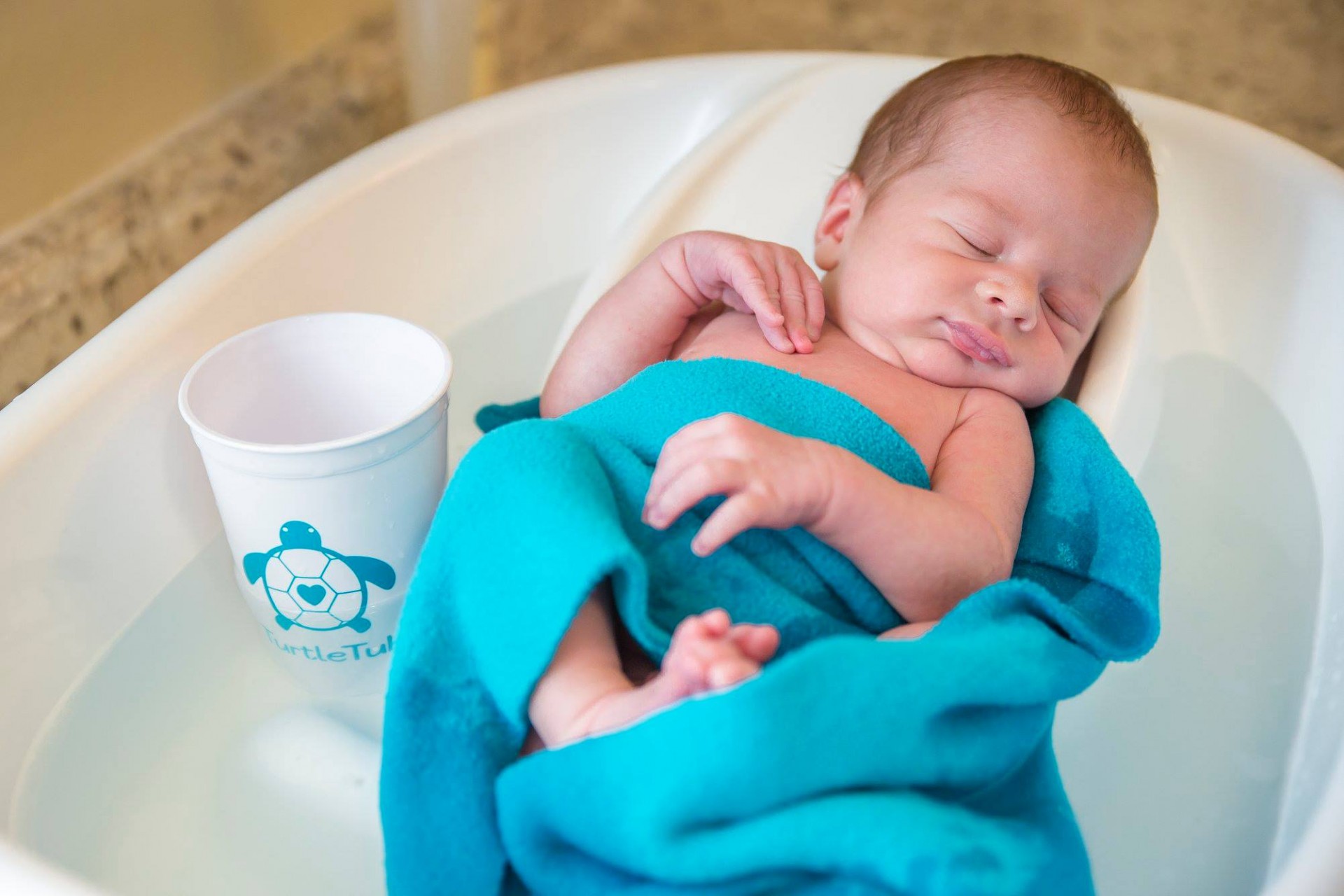 Baby in TurtleTub fleece blanket